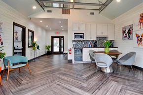 Spring Hill townhouse for rent - A modern kitchen with a wooden floor and a dining table with chairs.