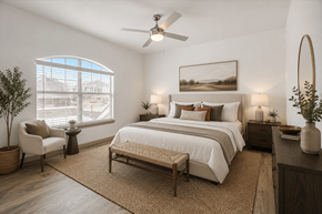 Pflugerville apartment for rent - A bedroom with a large bed, a chair, and a painting on the wall.