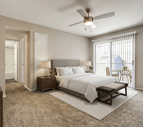 Georgetown apartment for rent - A bedroom with a large bed, a ceiling fan, and a window with blinds.