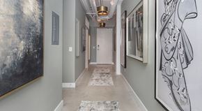 Atlanta apartment for rent - A hallway with a rug and artwork on the walls.
