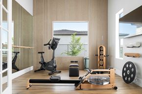 Casa Grande townhouse for rent - A home gym with a rowing machine, treadmill, and weights.