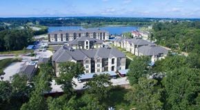 Montgomery apartment for rent - A large building complex with a lake in the background.