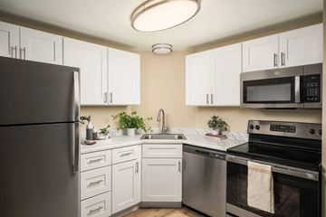 Denver apartment for rent - A kitchen with white cabinets and stainless steel appliances.