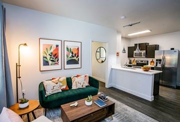 Las Vegas apartment for rent - A living room with a green couch and a coffee table.