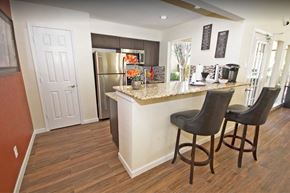 Dallas apartment for rent - a kitchen with a breakfast bar and a stainless steel refrigerator