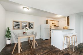 Dickson apartment for rent - A kitchen with a white refrigerator and a dining table with chairs.