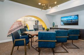 Cincinnati apartment for rent - A dining room with a large table and blue chairs.