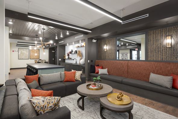 Nashville apartment for rent - A modern living room with a grey sofa and a wooden coffee table.