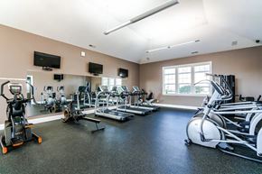 Grove City townhouse for rent - A gym with a variety of equipment including treadmills, stationary bikes, and weight machines.