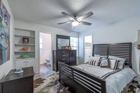 San Antonio apartment for rent - a bedroom with a bed and a ceiling fan