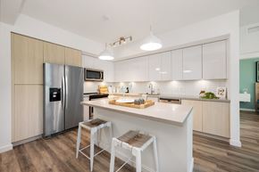 Fort Lauderdale apartment for rent - a kitchen with a large island and a stainless steel refrigerator
