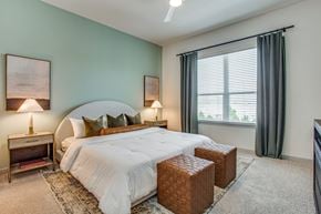 Fort Worth apartment for rent - A bedroom with a large bed and two lamps.