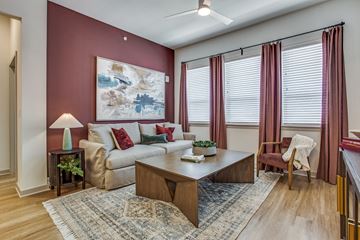 Fort Worth apartment for rent - A living room with a couch, chair, and a painting on the wall.