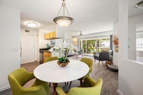 Fort Myers apartment for rent - a dining room with a white table and green chairs