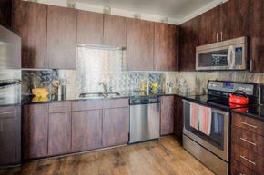 Denver apartment for rent - a kitchen with wooden cabinets and stainless steel appliances