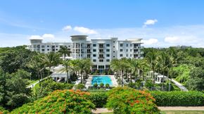 Boca Raton apartment for rent - a view of the resort with a pool and palm trees