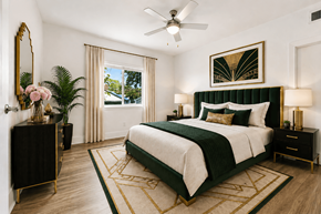 Apopka apartment for rent - A bedroom with a large bed and a ceiling fan.