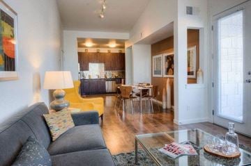Denver apartment for rent - A living room with a grey couch and a glass coffee table.