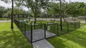Houston apartment for rent - a wrought iron fence around a playground in a park