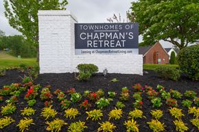 Spring Hill townhouse for rent - A sign for the Townhomes of Chapman's Retreat is surrounded by flowers.