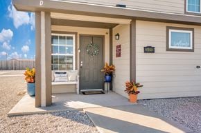 Hobbs townhouse for rent - A house entrance with a wreath on the door and a sign that says "Welcome Home".
