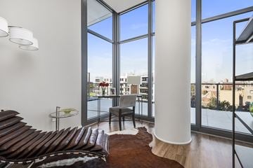 Chicago apartment for rent - A living room with a brown couch and a white column.