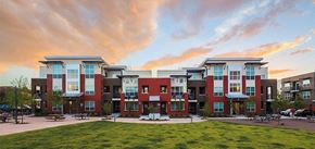 Denver apartment for rent - a row of apartment buildings with a green yard