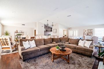 Tyler apartment for rent - A living room with a large sectional sofa and a coffee table in the center.