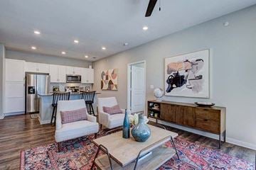 Conroe apartment for rent - A living room with a white sofa and a wooden coffee table.