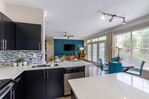 Atlanta apartment for rent - A kitchen with black cabinets and a white countertop.