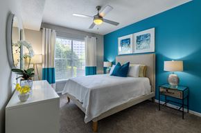 Atlanta apartment for rent - A bedroom with a bed, nightstand, and a ceiling fan.