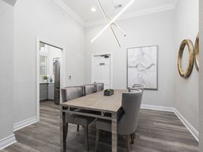Jacksonville apartment for rent - A dining room with a wooden table and grey chairs.