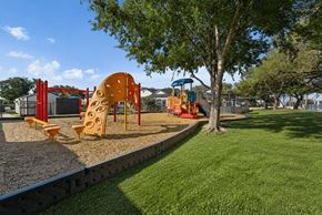 San Antonio apartment for rent - A playground with a slide, swings, and a climbing structure.