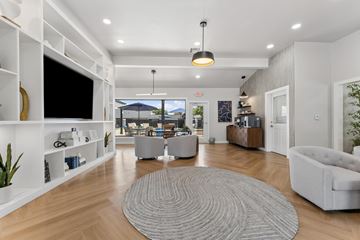 San Antonio apartment for rent - A modern living room with a grey rug on the floor and a flat screen TV mounted on the wall.