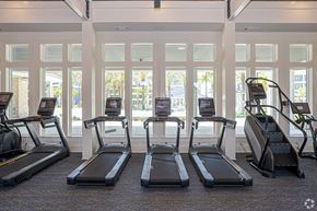 Panama City Beach apartment for rent - a row of treadmills in a gym with windows