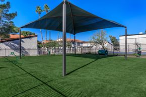Phoenix apartment for rent - a large shade sail in a backyard with a playground