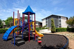 San Antonio apartment for rent - a playground at a school with a building in the background