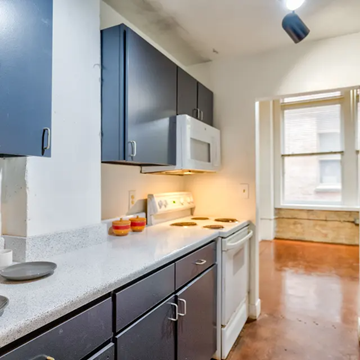 Fort Worth apartment for rent - A kitchen with a white microwave above a stove and a white dishwasher.