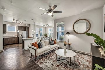 Houston apartment for rent - A living room with a white couch and a rug.