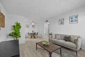 El Paso apartment for rent - A living room with a couch, coffee table, and a dining table.