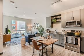 Fort Collins apartment for rent - A modern kitchen with a dining table and chairs in the foreground.