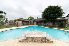 Houston apartment for rent - a swimming pool with a house in the background
