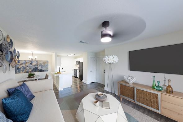 Jacksonville apartment for rent - A modern living room with a white sofa and a large painting on the wall.