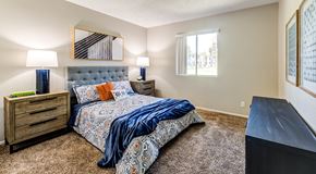 Ontario apartment for rent - A bedroom with a large bed and a dresser.