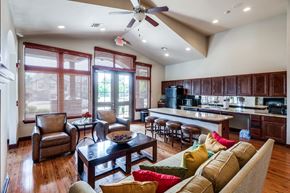 Shreveport apartment for rent - a large living room with a kitchen and a ceiling fan