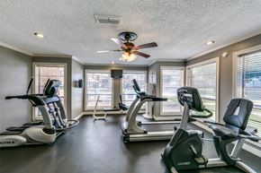 Longview apartment for rent - the gym has plenty of cardio equipment and a ceiling fan