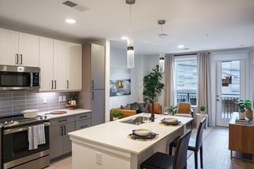 Charlotte apartment for rent - A modern kitchen with a dining table set for two.