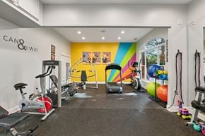 Concord apartment for rent - A gym with a variety of equipment including treadmills, weights, and exercise machines.