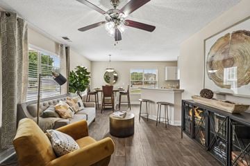 Aberdeen townhouse for rent - A living room with a yellow chair and a ceiling fan.