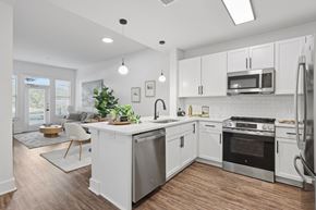 Atlanta apartment for rent - A modern kitchen with white cabinets and stainless steel appliances.